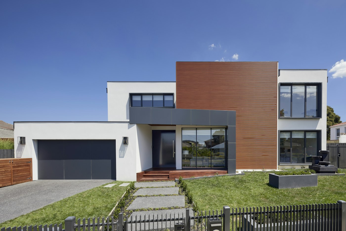 Contemporary home with generous windows and leafy surroundings